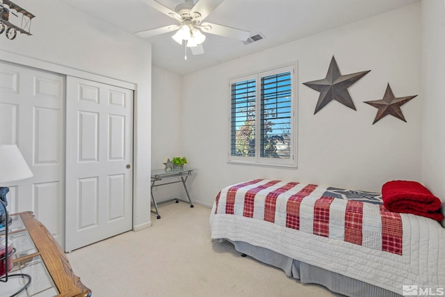 bedroom with a closet, light colored carpet, and ceiling fan