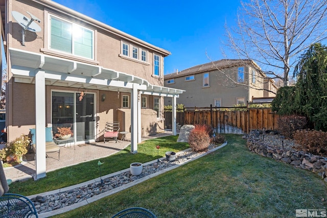 rear view of property with a lawn, a pergola, and a patio