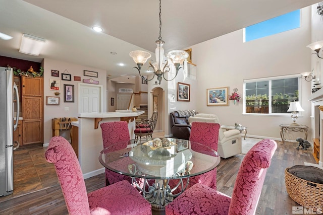 dining room featuring an inviting chandelier and dark wood-type flooring