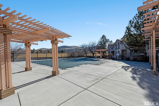 view of swimming pool with a mountain view, a pergola, and a patio