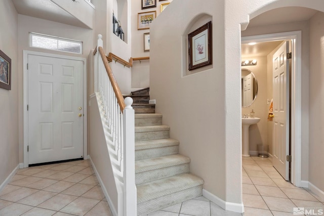 foyer entrance with light tile patterned floors