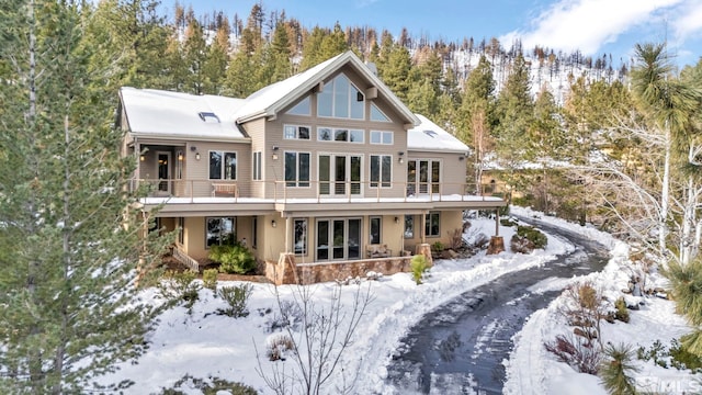 view of snow covered rear of property