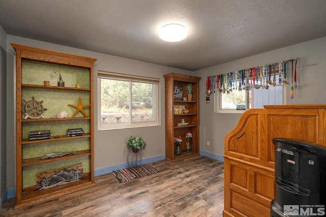 office with a textured ceiling, hardwood / wood-style flooring, and plenty of natural light