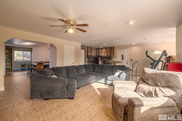 living room featuring a textured ceiling and ceiling fan