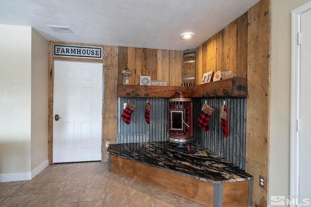 kitchen featuring wood walls and a textured ceiling