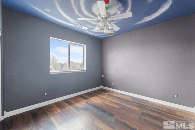 unfurnished room featuring visible vents, a ceiling fan, baseboards, and wood finished floors