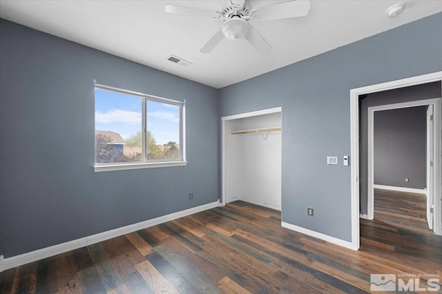 unfurnished bedroom featuring baseboards, visible vents, and wood finished floors