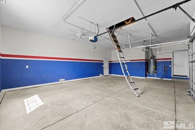 garage with a ceiling fan, baseboards, strapped water heater, and a garage door opener