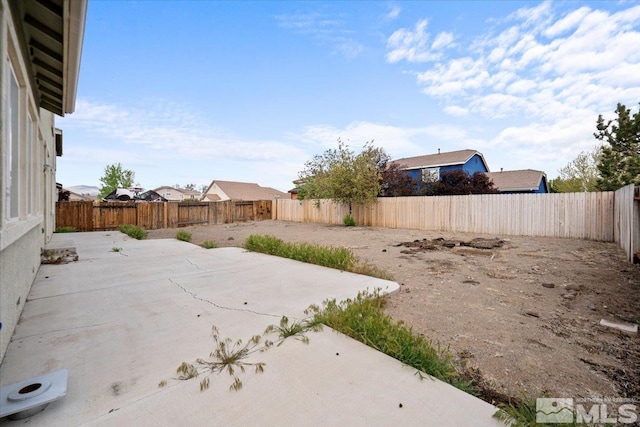 view of yard with a fenced backyard and a patio area
