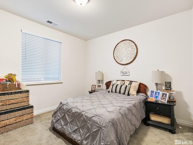 bedroom featuring light carpet