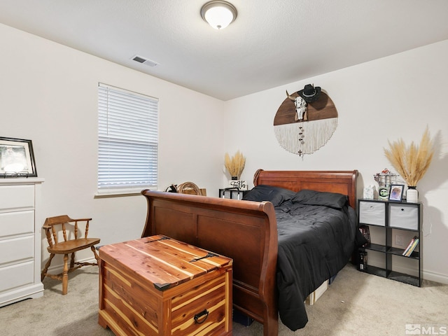 bedroom with light colored carpet