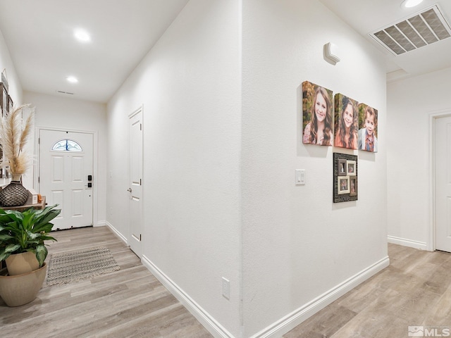 foyer entrance with light wood-type flooring