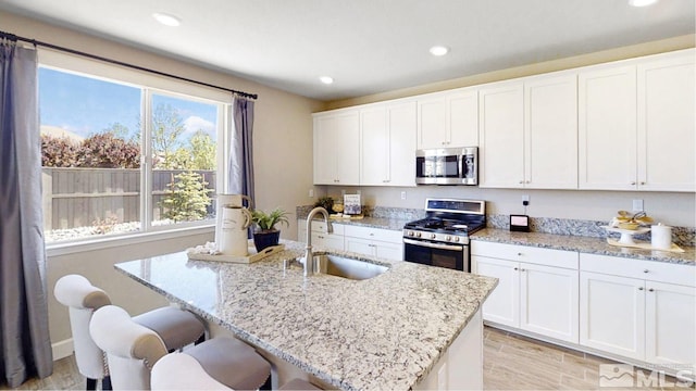 kitchen with white cabinets, sink, and appliances with stainless steel finishes