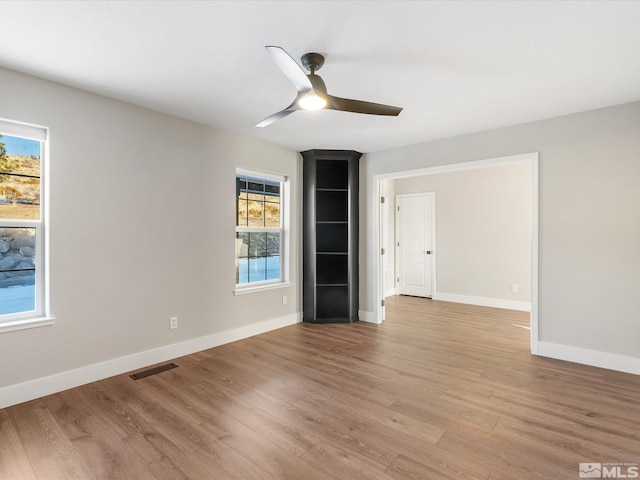 spare room featuring ceiling fan and light hardwood / wood-style flooring