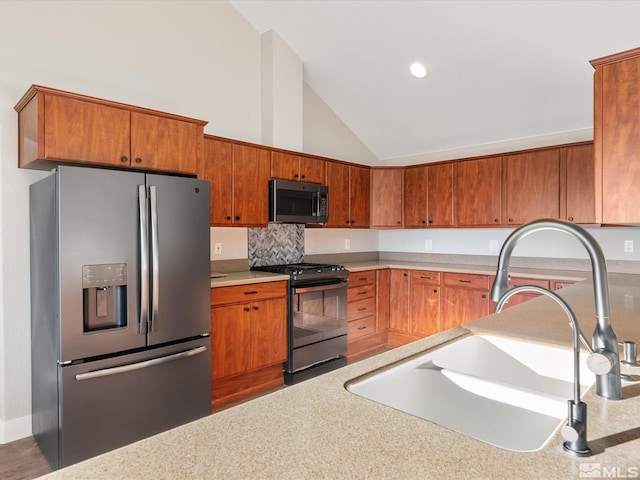 kitchen featuring sink, stainless steel appliances, and high vaulted ceiling