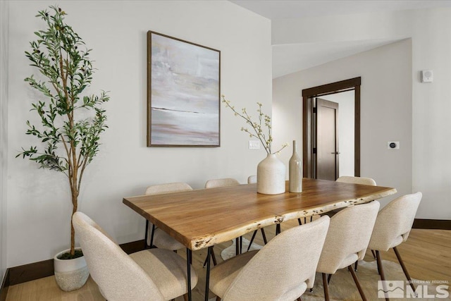 dining space with hardwood / wood-style floors