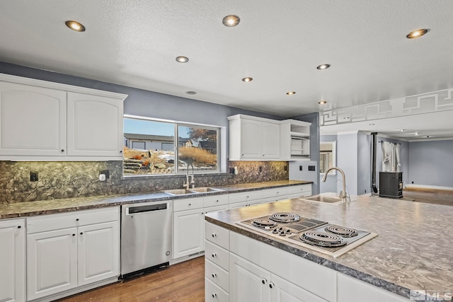 kitchen featuring wood-type flooring, white cabinetry, sink, and appliances with stainless steel finishes