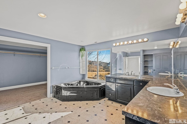 bathroom with a tub to relax in and vanity