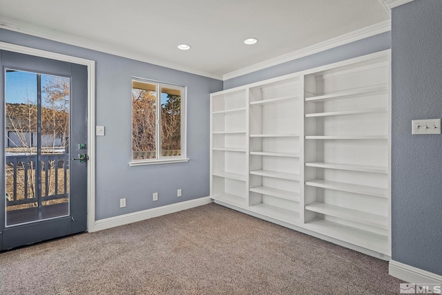 carpeted spare room featuring ornamental molding