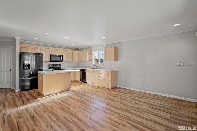 kitchen featuring black appliances, light brown cabinets, and light hardwood / wood-style flooring