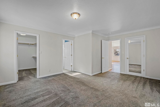 unfurnished bedroom featuring carpet, a spacious closet, and a closet