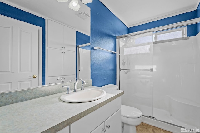 bathroom featuring tile patterned floors, vanity, toilet, and a shower with door