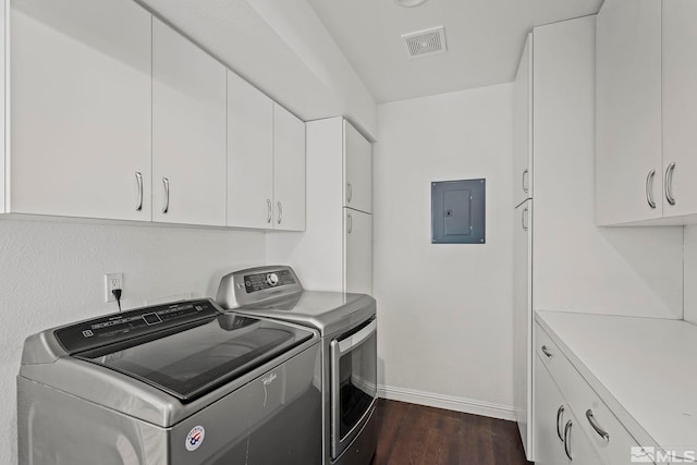 laundry area featuring electric panel, dark wood-type flooring, cabinets, and washing machine and dryer