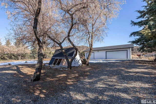 view of front facade with an outdoor structure and a garage