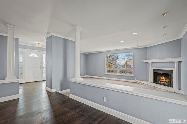 unfurnished living room featuring a high end fireplace, dark hardwood / wood-style flooring, and ornamental molding