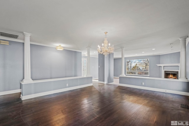 unfurnished living room with a chandelier, crown molding, and dark wood-type flooring