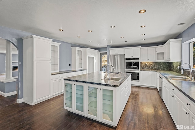 kitchen featuring plenty of natural light, dark hardwood / wood-style flooring, sink, and appliances with stainless steel finishes