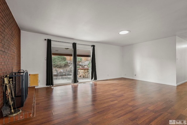 unfurnished living room with dark hardwood / wood-style floors and a fireplace