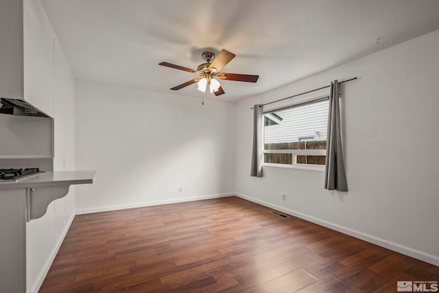 spare room with ceiling fan and dark hardwood / wood-style floors