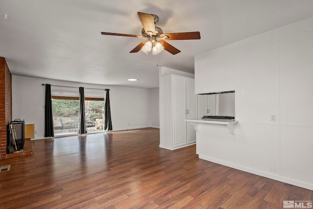 unfurnished living room with ceiling fan and dark hardwood / wood-style flooring