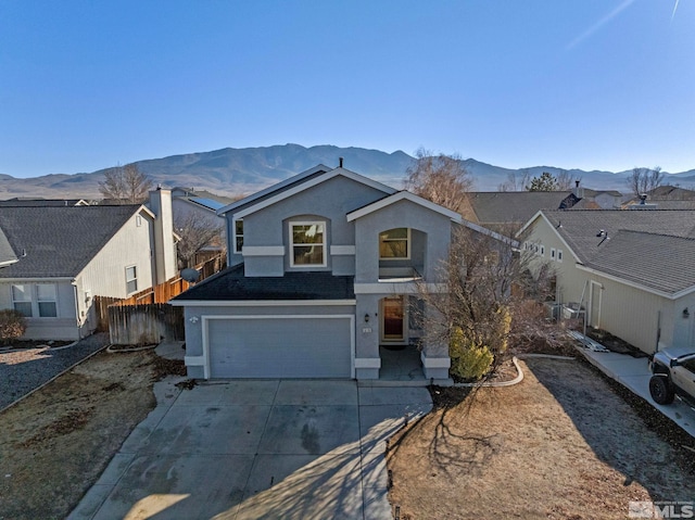 front facade with a mountain view and a garage