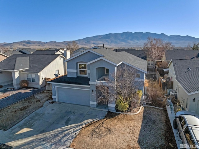 view of front of property featuring a mountain view and a garage