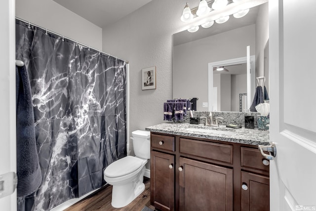 bathroom featuring hardwood / wood-style floors, vanity, and toilet