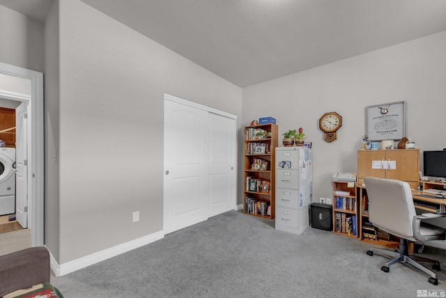 carpeted office space with washer / dryer