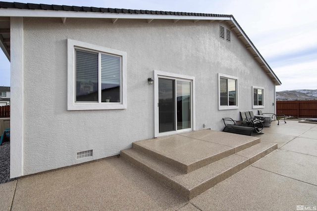 back of house featuring a mountain view and a patio area