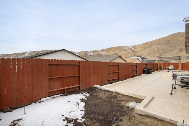 snowy yard featuring a mountain view