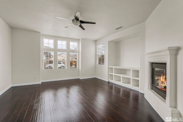 unfurnished living room with dark hardwood / wood-style floors and ceiling fan