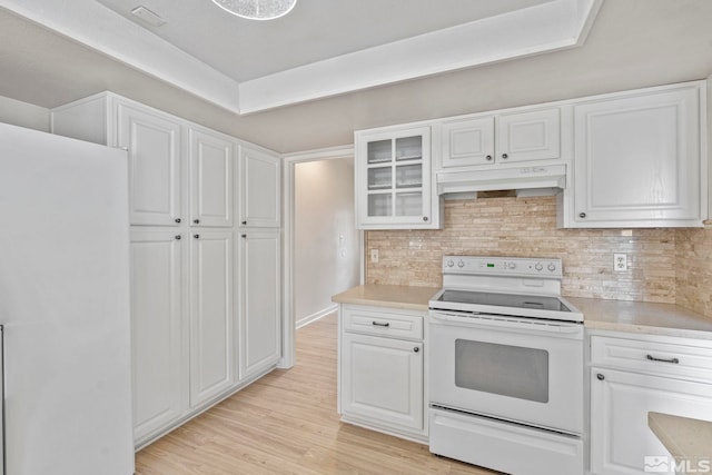 kitchen with electric range, white cabinets, and light hardwood / wood-style flooring