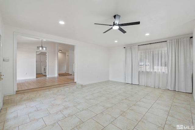 unfurnished room with ceiling fan and light wood-type flooring