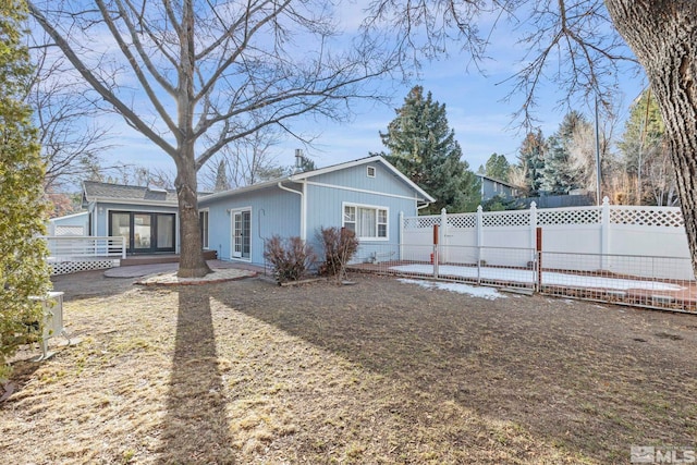 back of property featuring a wooden deck