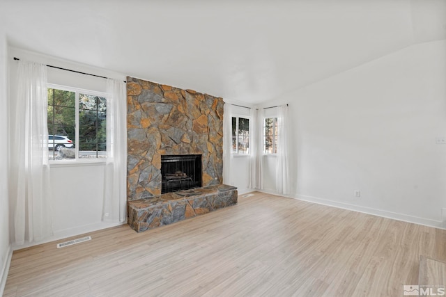 unfurnished living room with a fireplace and light hardwood / wood-style flooring