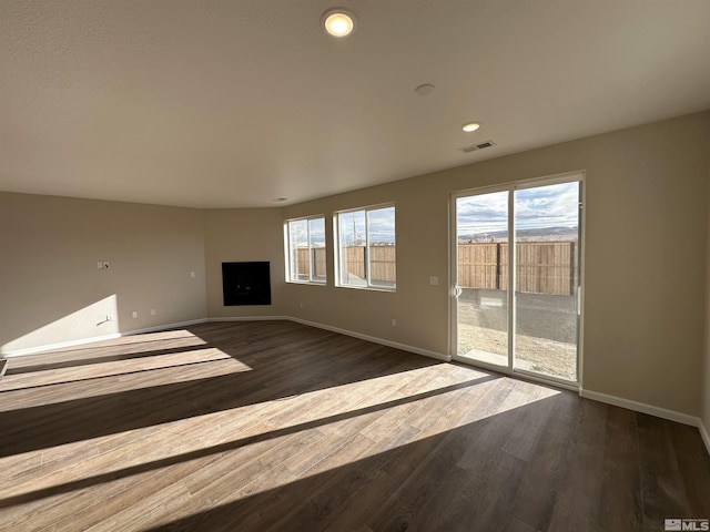 unfurnished living room featuring dark wood-type flooring