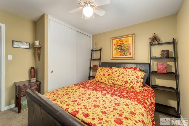 bedroom featuring ceiling fan, a closet, and light colored carpet