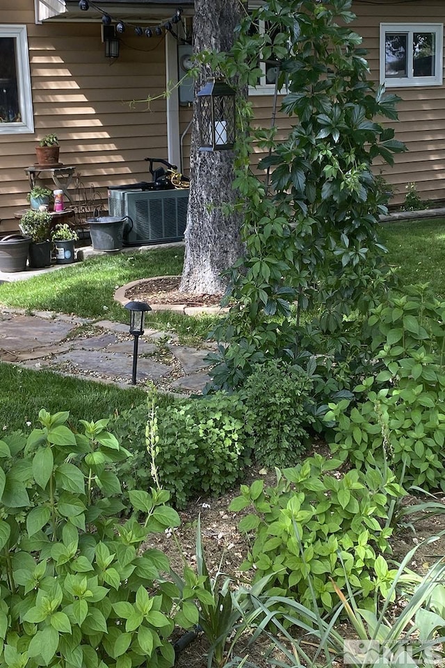 view of yard featuring central air condition unit