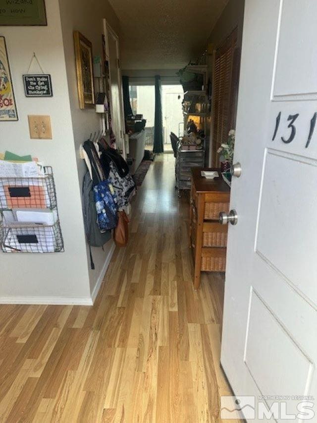 corridor with wood-type flooring