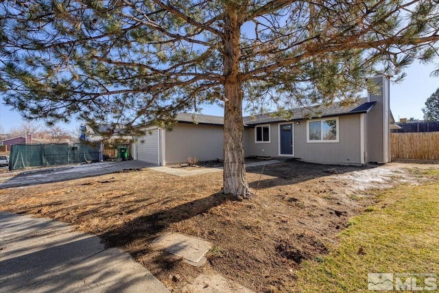 rear view of house featuring a garage